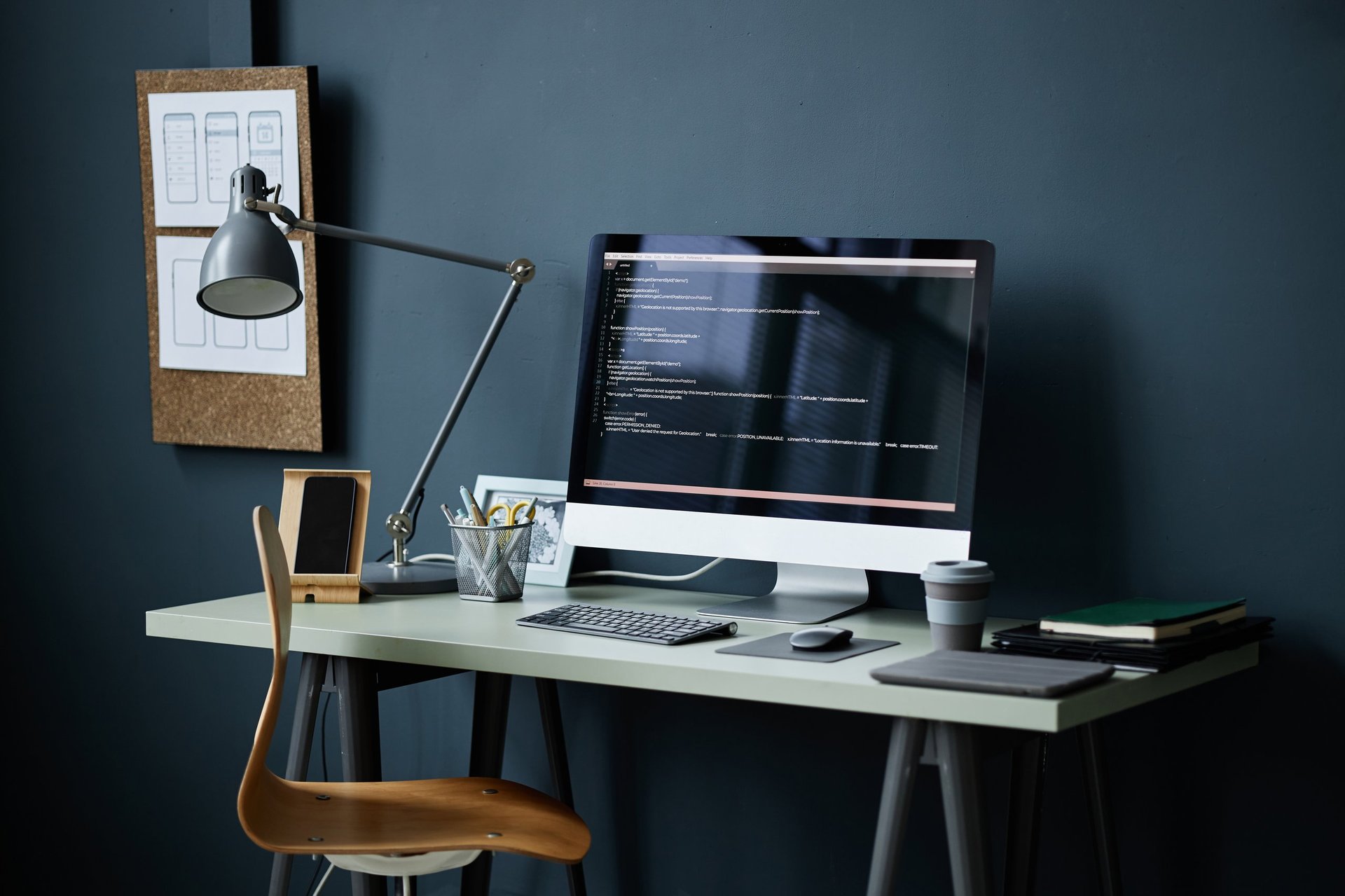 Modern workspace with computer displaying programming code